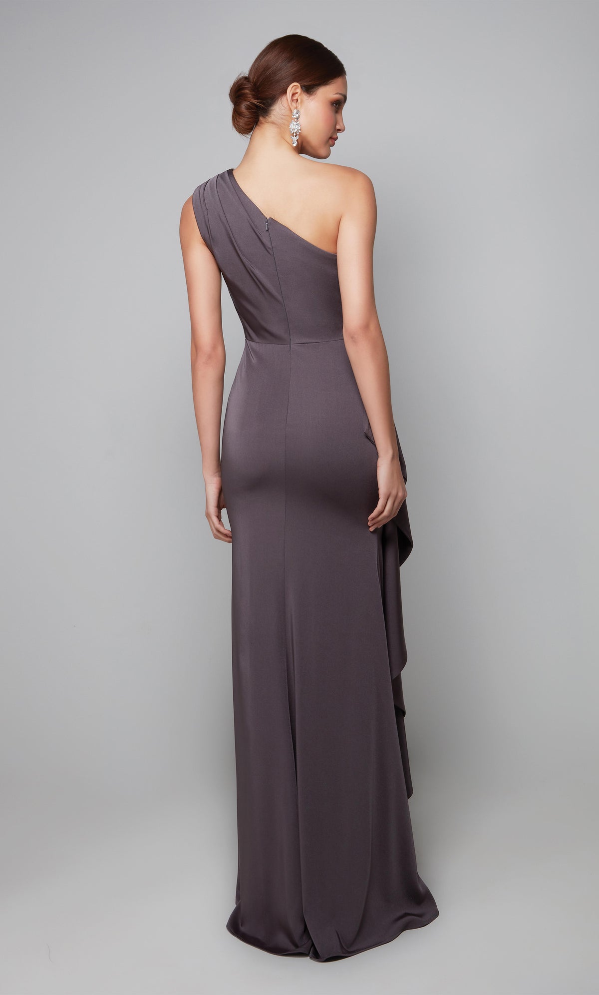 Long one shoulder side ruffle gown with ruching detail, a closed back, and train.